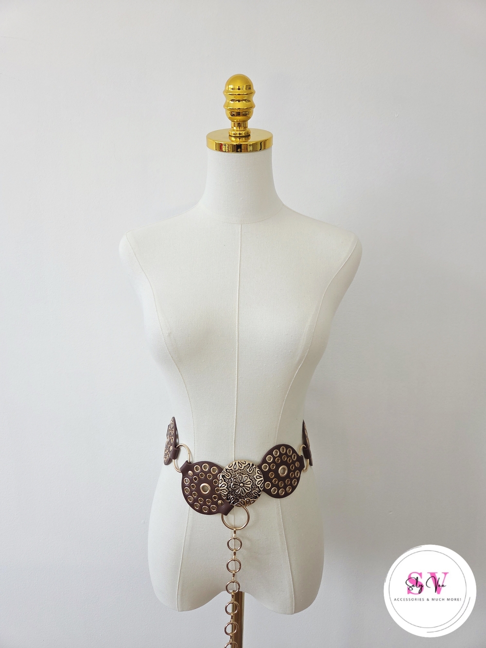 Brown belt with gold circular embellishments and central floral design